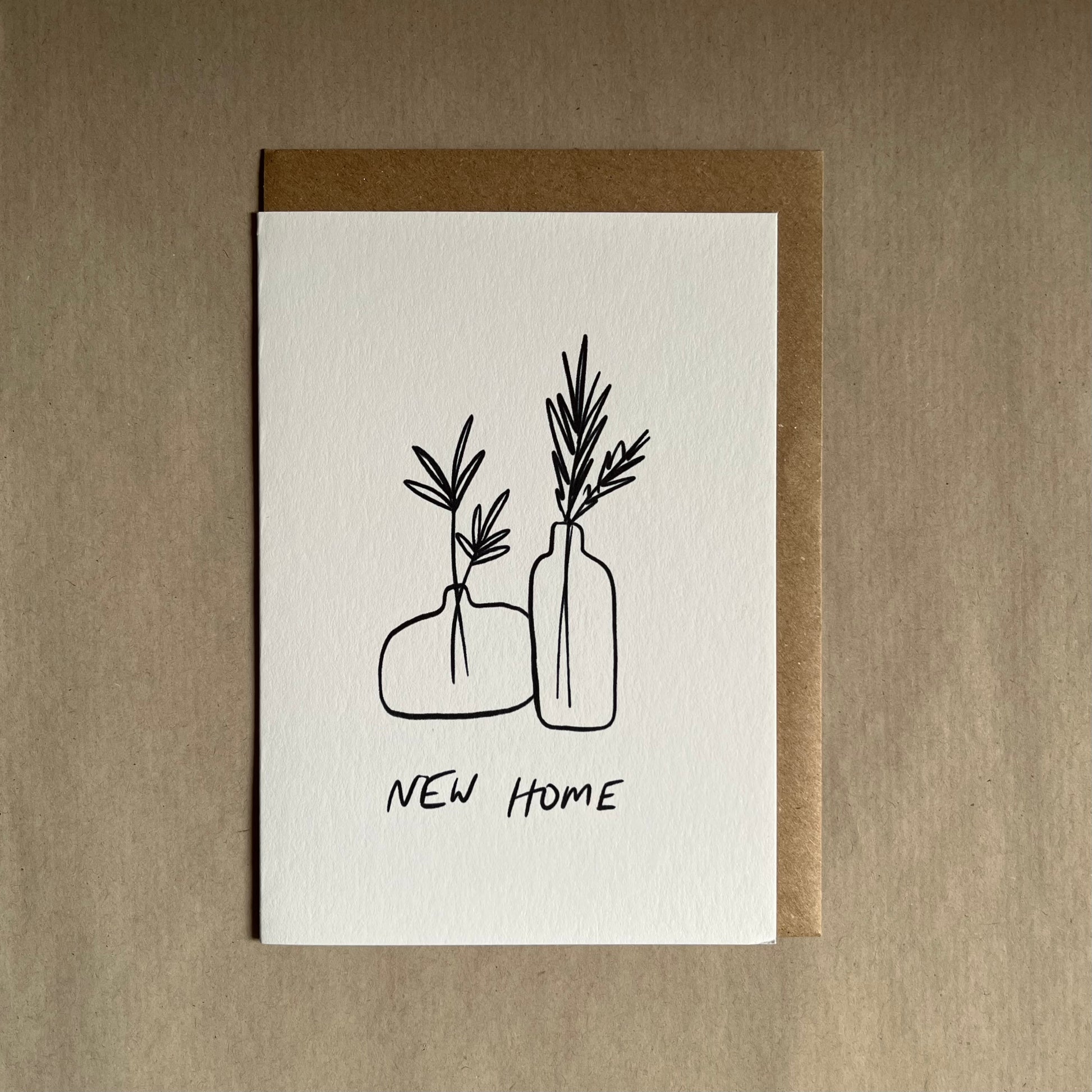 New home greeting card with illustrations of vases and plants on a beige background with the text ‘new home’ underneath