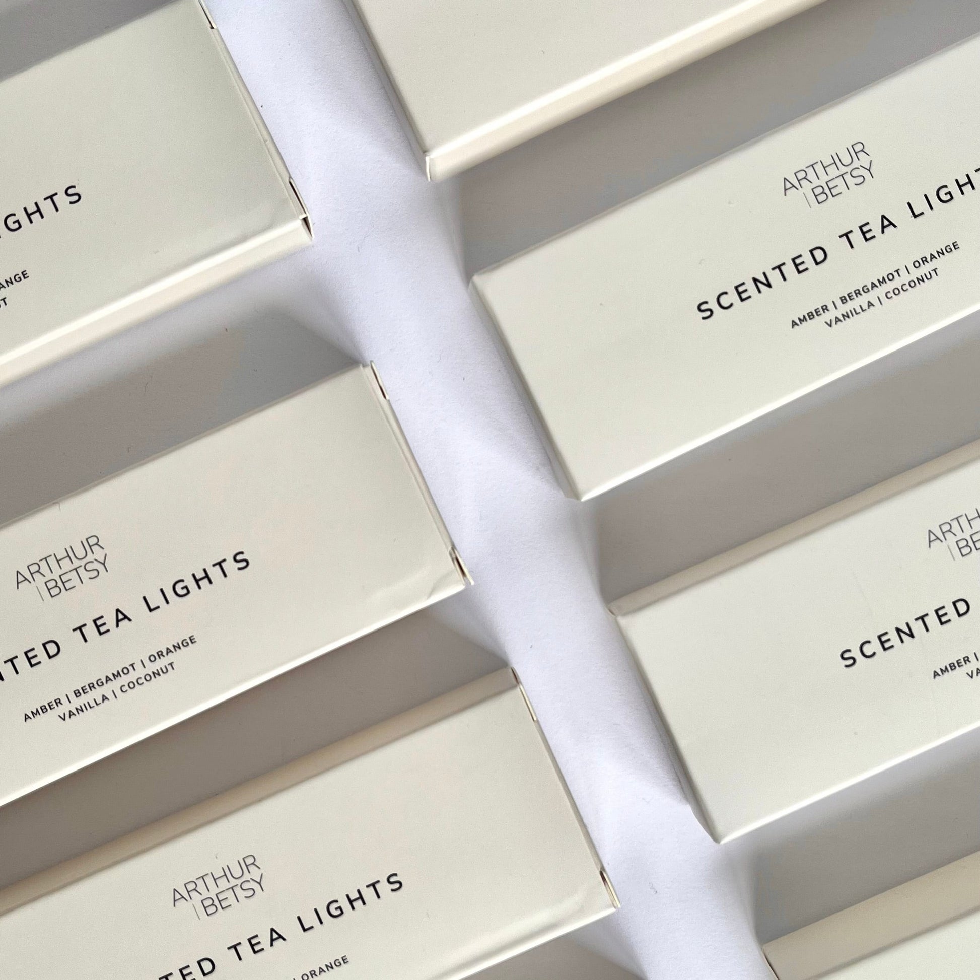 Image of a number of scented tea light beige boxes shown at a angle