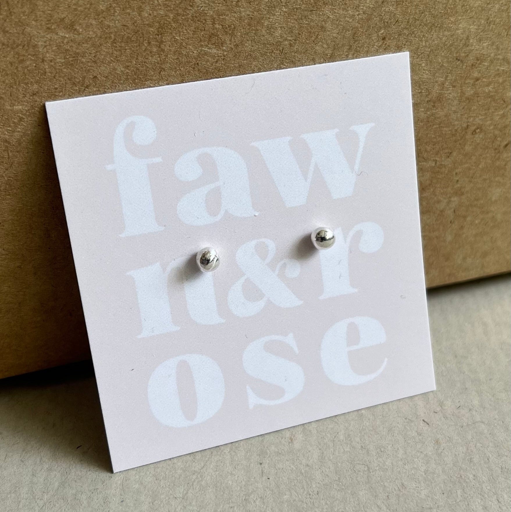 Zero Waste Pebble Studs - Recycled Silver Ball Earrings on soft pink card with words fawn and rose.