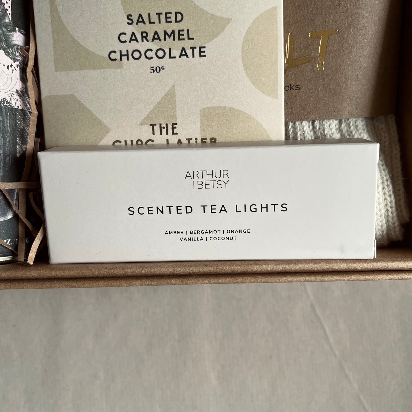 Close up image of Arthur Betsy scented tea lights included in A Hug in a Box luxury gift box.