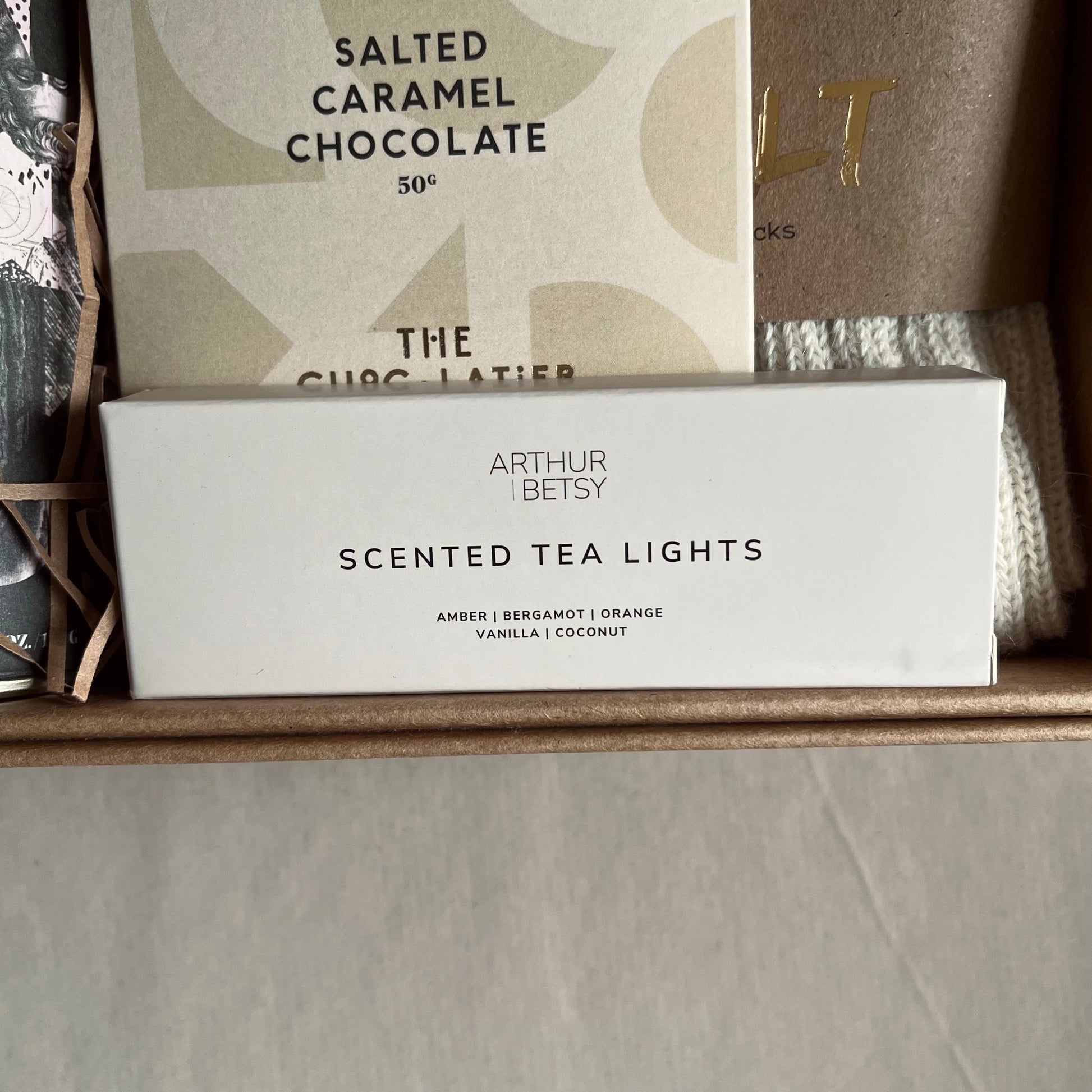 Close up image of Arthur Betsy scented tea lights included in A Hug in a Box luxury gift box.