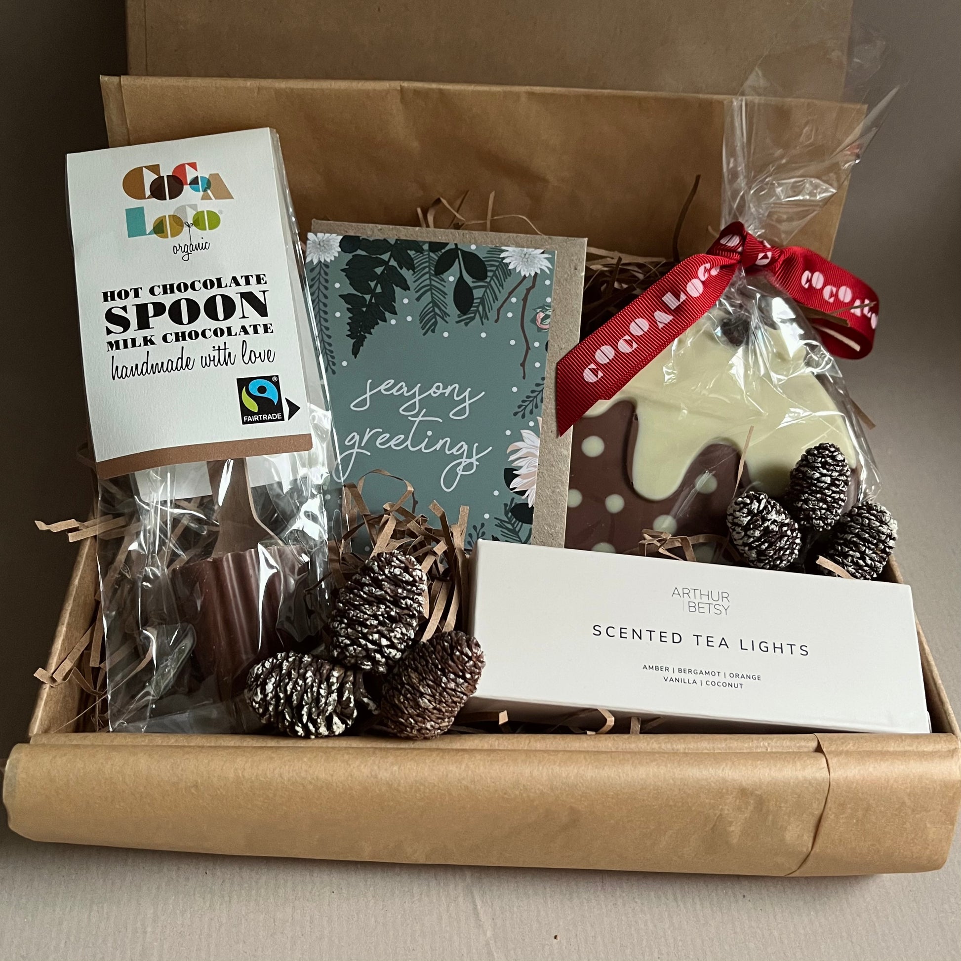 Cosy Mini Gift Box with hot chocolate spoon, chocolate Christmas pudding and scented tea lights – a thoughtful winter comfort gift from The Gift Box Cheshire.