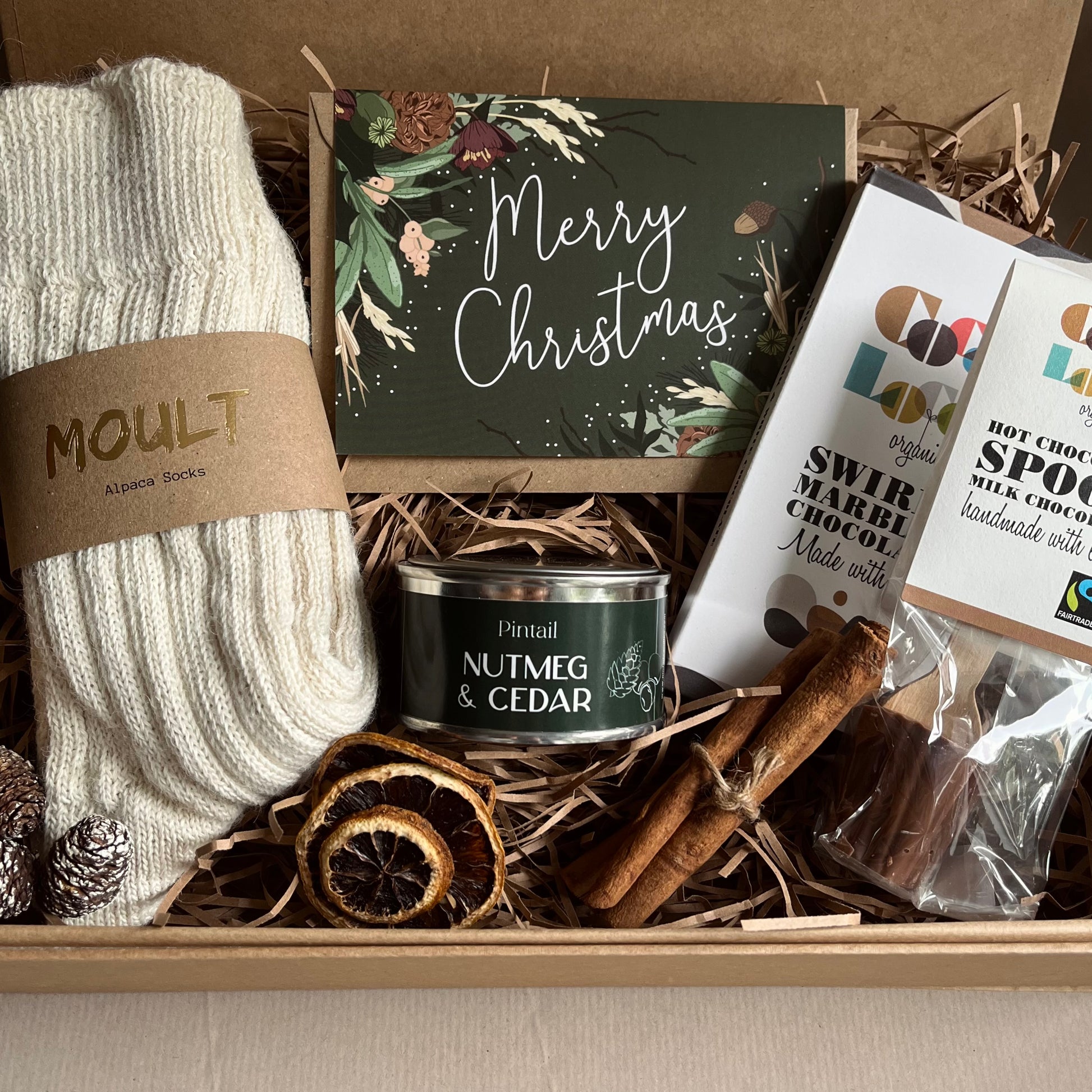 The Cosy Christmas Gift Box with alpaca socks, nutmeg and cedar candle, marbled chocolate bar and hot chocolate spoon – a luxury festive pamper gift for her from The Gift Box Cheshire.